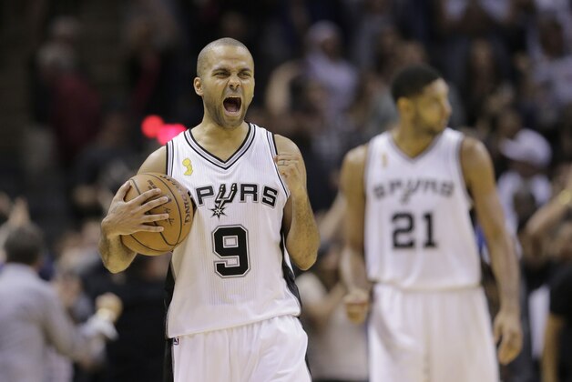 San Antonio Spurs' Tony Parker (9), of France, celebrates following an NBA basketball game against the Dallas Mavericks, Tuesday, Oct. 28, 2014, in San Antonio. San Antonio won 101-100. (AP Photo/Eric Gay)