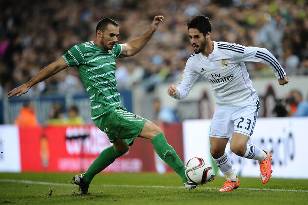 Real Madrid's  Francisco Isco, right, duels for the ball against Cornella's Pelegri during a Copa del Rey soccer match in Cornella Llobregat, Spain, Wednesday, Oct. 29, 2014. (AP Photo/Manu Fernandez)