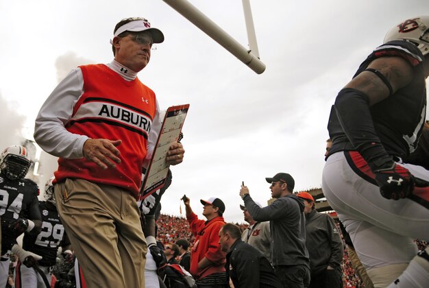 Nov 8, 2014; Auburn, AL, USA; Auburn Tigers head coach Gus Malzahn runs onto the field with his team for the game against the Texas A&M Aggies at Jordan Hare Stadium. Texas A&M won 41-38. Mandatory Credit: Shanna Lockwood-USA TODAY Sports