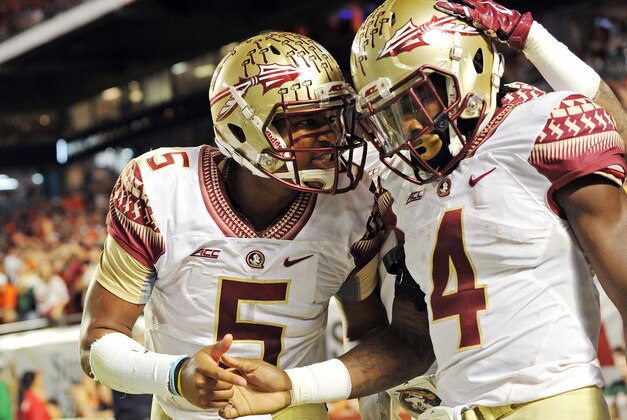Nov 15, 2014; Miami Gardens, FL, USA; Florida State Seminoles quarterback Jameis Winston (left) celebrates with running back Dalvin Cook (right) after Cook scored a touchdown against the Miami Hurricanes during the second half at Sun Life Stadium.  FSU won 30-26. Mandatory Credit: Steve Mitchell-USA TODAY Sports