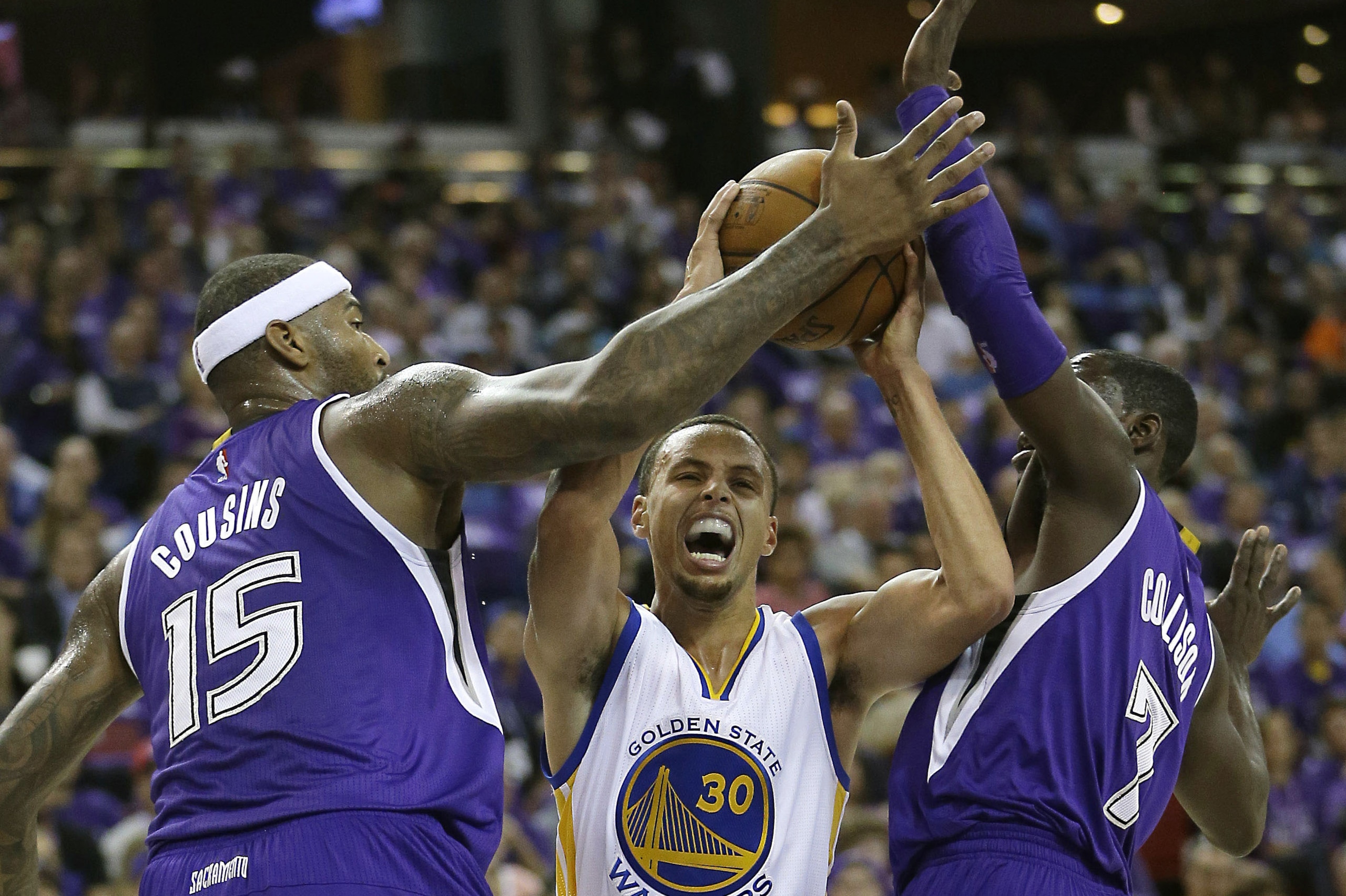 Golden State Warriors guard Stephen Curry, center, tries to drive between Sacramento Kings' DeMarcus Cousins, left, Darren Collison during the first half of an NBA basketball game in Sacramento, Calif., Wednesday, Oct. 29 2014. (AP Photo/Rich Pedroncelli) Golden State Warriors guard Stephen Curry, center, tries to drive between Sacramento Kings' DeMarcus Cousins, left, Darren Collison during the first half of an NBA basketball game in Sacramento, Calif., Wednesday, Oct. 29 2014. (AP Photo/Rich Pedroncelli)