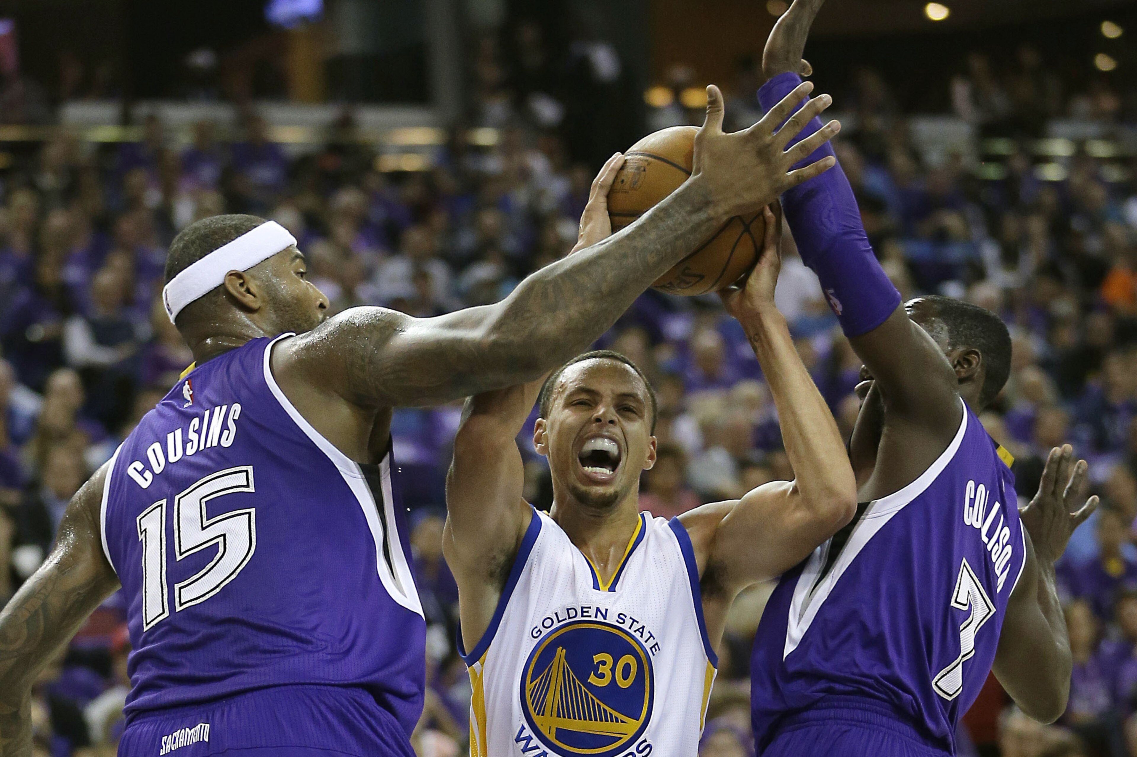 Golden State Warriors guard Stephen Curry, center, tries to drive between Sacramento Kings' DeMarcus Cousins, left, Darren Collison during the first half of an NBA basketball game in Sacramento, Calif., Wednesday, Oct. 29 2014. (AP Photo/Rich Pedroncelli) Golden State Warriors guard Stephen Curry, center, tries to drive between Sacramento Kings' DeMarcus Cousins, left, Darren Collison during the first half of an NBA basketball game in Sacramento, Calif., Wednesday, Oct. 29 2014. (AP Photo/Rich Pedroncelli)