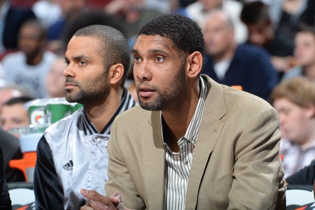 PHILADELPHIA, PA - DECEMBER 1:  Tim Duncan #21 of the San Antonio Spurs watches the game against the Philadelphia 76ers from the bench on December 1, 2014 at the Wells Fargo Center in Philadelphia, Pennsylvania.  NOTE TO USER: User expressly acknowledges and agrees that, by downloading and or using this Photograph, user is consenting to the terms and conditions of the Getty Images License Agreement. Mandatory Copyright Notice: Copyright 2014 NBAE (Photo by Jesse D. Garrabrant/NBAE via Getty Images)