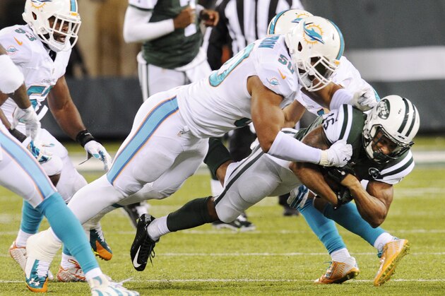 New York Jets wide receiver Percy Harvin (16) is tackled by Miami Dolphins defensive end Olivier Vernon (50) during the second quarter of an NFL football game, Monday, Dec. 1, 2014, in East Rutherford, N.J. (AP Photo/Bill Kostroun)