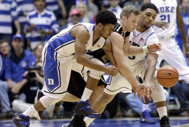 Duke's Quinn Cook, left, and Jahlil Okafor chase a loose ball with Army's Kyle Wilson, center, during the second half of an NCAA college basketball game in Durham, N.C., Sunday, Nov. 30, 2014. Duke won 93-73. (AP Photo/Gerry Broome)