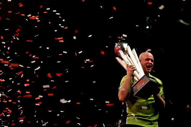 LONDON, ENGLAND - JANUARY 01:  Michael van Gerwen of The Netherlands celebrates with the trophy after winning the final of the Ladbrokes.com World Darts Championships at Alexandra Palace on January 1, 2014 in London, England.  (Photo by Ben Hoskins/Getty Images)