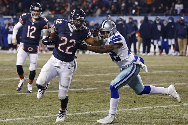 Chicago Bears running back Matt Forte (22) runs against Dallas Cowboys cornerback Orlando Scandrick (32) on his way to a touchdown during the second half of an NFL football game, Monday, Dec. 9, 2013, in Chicago. (AP Photo/Charles Rex Arbogast)