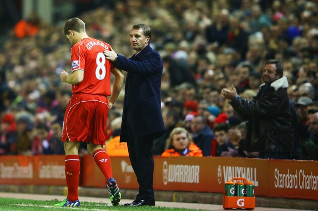 LIVERPOOL, ENGLAND - NOVEMBER 29:  A fan applauds as Steven Gerrard of Liverpool prepares to come onto the pitch as a substitute alongside Brendan Rodgers manager of Liverpool during the Barclays Premier League match between Liverpool and Stoke City at Anfield on November 29, 2014 in Liverpool, England.  (Photo by Richard Heathcote/Getty Images)