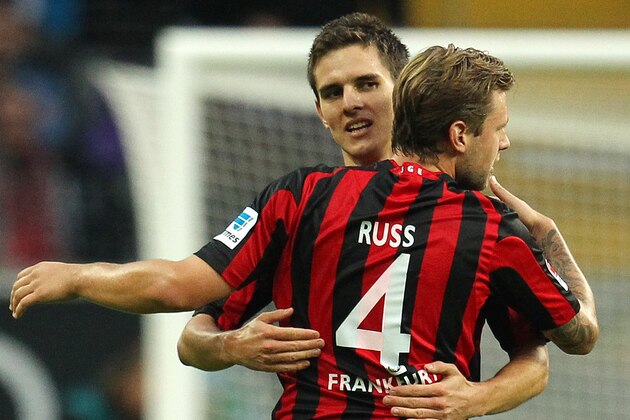 Frankfurt's Johannes Flum, background celebrates his side's opening goal with teammate Marco Russ during a German soccer Bundesliga match between Eintracht Frankfurt and Hamburger SV in Frankfurt, Germany, Saturday, Sept. 28, 2013. (AP Photo/Michael Probst)