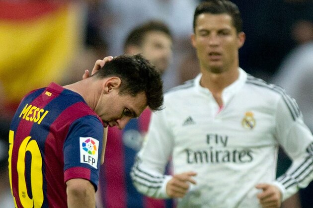 MADRID, SPAIN - OCTOBER 25: Lionel Messi (2nd R) of FC Barcelona reacts as Real madrid CF players Cristiano Ronaldo (R), Francisco Roman Alarcon (Isco) (2ndL) and Marcelo (L) walk on after celebrating his team«s third goal during the La Liga match between Real Madrid CF and FC Barcelona at Estadio Santiago Bernabeu on October 25, 2014 in Madrid, Spain.  (Photo by Gonzalo Arroyo Moreno/Getty Images)