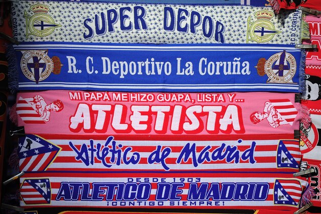 MADRID, SPAIN - NOVEMBER 30: RC Deportivo and Club Atletico de Madrid scarves are for sale outside the Vicente Calderon stadiun before the La Liga match between Club Atletico de Madrid and RC Deportivo La Coruna on November 30, 2014 in Madrid, Spain.  An RC Deportivo La Coruna supporter was critically injured when fightihng broke out between rival fans before the match early in the morning outside the stadium.  (Photo by Denis Doyle/Getty Images)