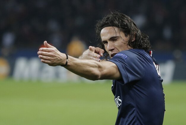PSG's Edinson Cavani celebrates his opening goal during the Champions League Group F soccer match between Paris Saint Germain and Ajax at Parc des Princes stadium in Paris, France, Tuesday, Nov. 25, 2014. (AP Photo/Francois Mori)