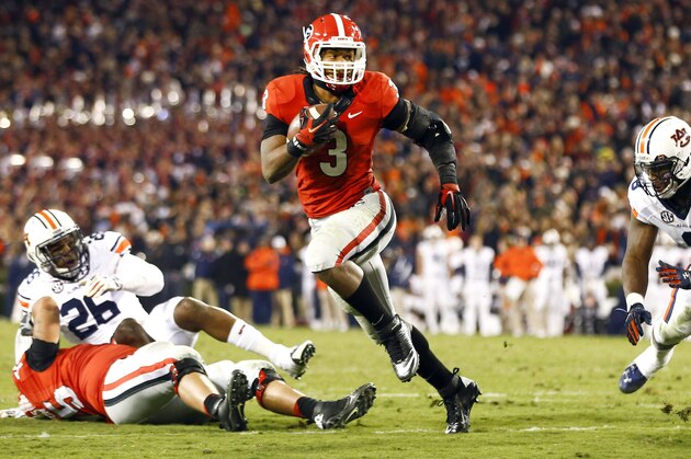 Georgia running back Todd Gurley (3) runs between Auburn linebacker Justin Garrett (26) and Auburn linebacker Cassanova McKinzy (8) to score a touchdown in the second half of an NCAA college football game Saturday, Nov. 15, 2014, in Athens, Ga. (AP Photo/John Bazemore)