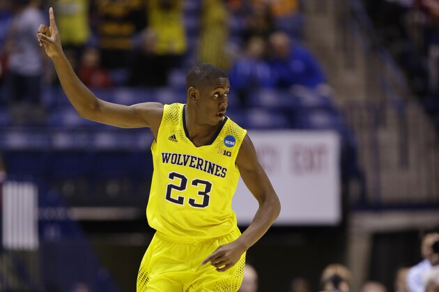 Michigan guard Caris LeVert (23) reacts during the first half of an NCAA Midwest Regional semifinal college basketball tournament game against the Tennessee Friday, March 28, 2014, in Indianapolis. (AP Photo/Michael Conroy)
