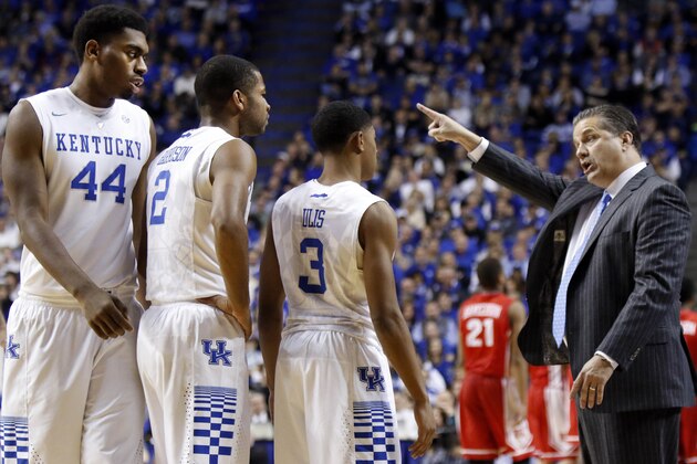 Kentucky's Dakari Johnson (44), Aaron Harrison (2) and Tyler Ulis listen to head coach John Calipari during the second half of an NCAA college basketball game against Boston University, Friday, Nov. 21, 2014, in Lexington, Ky. Kentucky won 89-65. (AP Photo/James Crisp)
