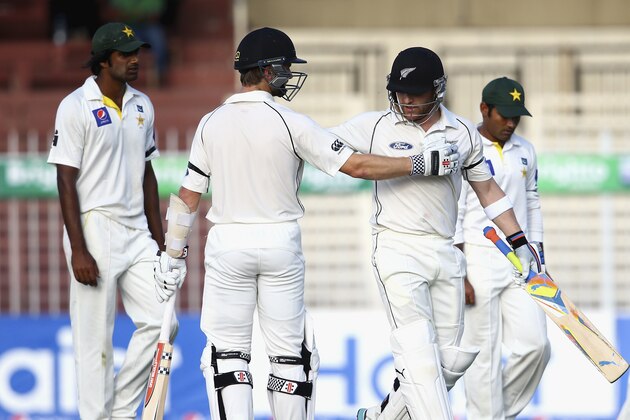 SHARJAH, UNITED ARAB EMIRATES - NOVEMBER 28:  Kane Williamson congratulates Brendon McCullum on reaching his century during day two of the third test between Pakistan and New Zealand at Sharjah Stadium on November 28, 2014 in Sharjah, United Arab Emirates.  (Photo by Francois Nel/Getty Images)
