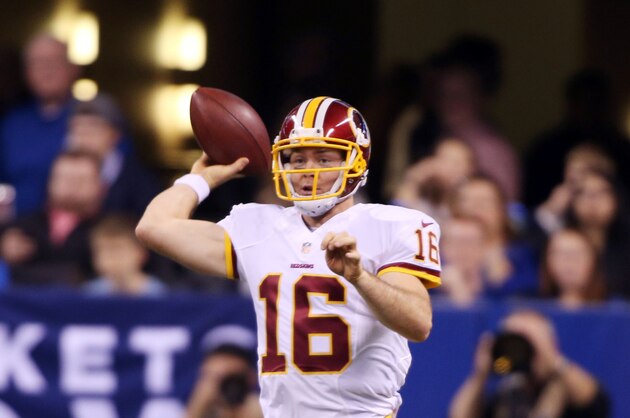 Nov 30, 2014; Indianapolis, IN, USA; Washington Redskins quarterback Colt McCoy (16) rolls out to throw a pass against the Indianapolis Colts at Lucas Oil Stadium. Mandatory Credit: Brian Spurlock-USA TODAY Sports