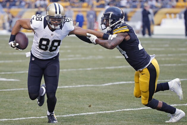 New Orleans Saints wide receiver Nick Toon (88) stiff arms Pittsburgh Steelers cornerback Ike Taylor (24) en route to the end zone after making a catch during the second half of an NFL football game in Pittsburgh, Sunday, Nov. 30, 2014. (AP Photo/Gene J. Puskar)