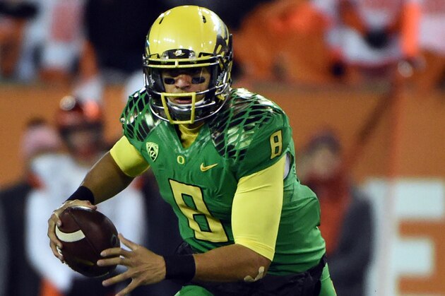 CORVALLIS, OR - NOVEMBER 29: Quarterback Marcus Mariota #8 of the Oregon Ducks runs with the ball during the third quarter of the game against the Oregon State Beavers at Reser Stadium on November 29, 2014 in Corvallis, Oregon. (Photo by Steve Dykes/Getty Images)