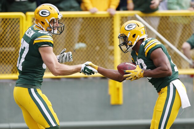 Green Bay Packers' Jordy Nelson (87) is congratulated by teammate Randall Cobb after Nelson's touchdown catch during the first half of an NFL football game against the Carolina Panthers Sunday, Oct. 19, 2014, in Green Bay, Wis. (AP Photo/Mike Roemer)