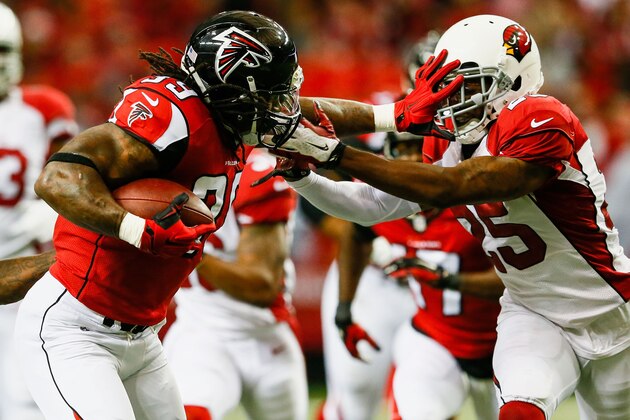 ATLANTA, GA - NOVEMBER 30: Steven Jackson #39 of the Atlanta Falcons stiff arms Jerraud Powers #25 of the Arizona Cardinals during the first half at the Georgia Dome on November 30, 2014 in Atlanta, Georgia.  (Photo by Kevin C. Cox/Getty Images)