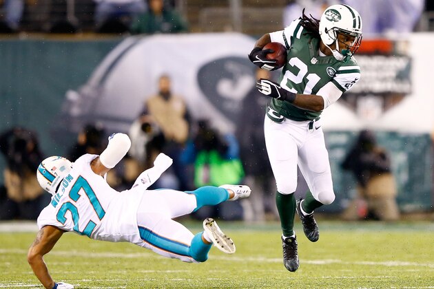 EAST RUTHERFORD, NJ - DECEMBER 01:   Chris Johnson #21 of the New York Jets runs the ball against Jimmy Wilson #27 of the Miami Dolphins during their game at MetLife Stadium on December 1, 2014 in East Rutherford, New Jersey.  (Photo by Al Bello/Getty Images)