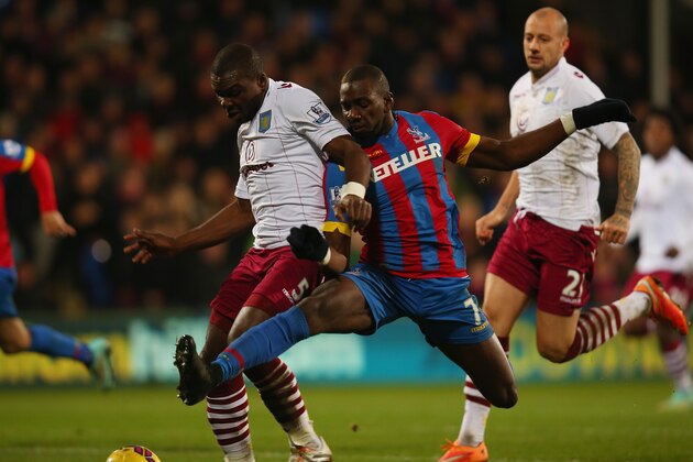 LONDON, ENGLAND - DECEMBER 02: Yannick Bolasie of Crystal Palace (R) tackles Jores Okore of Aston Villa during the Barclays Premier League match between Crystal Palace and Aston Villa at Selhurst Park on December 2, 2014 in London, England.  (Photo by Bryn Lennon/Getty Images)