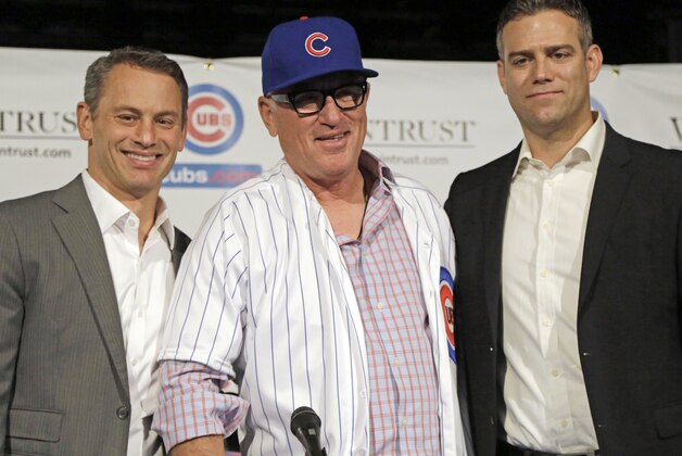 Chicago Cubs general manager Jed Hoyer, left, and president of baseball operations Theo Epstein stand with Joe Maddon as he is introduced as the new manager of the Cubs baseball team Monday, Nov. 3, 2014, in Chicago. (AP Photo/M. Spencer Green)
