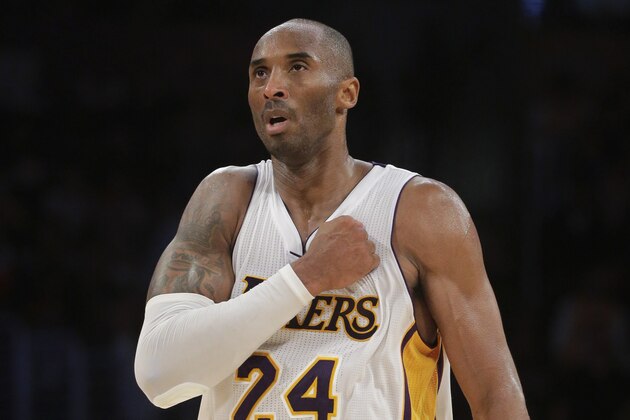 Los Angeles Lakers' Kobe Bryant reacts after making a basket against the Toronto Raptors in overtime of an NBA basketball game Sunday, Nov. 30, 2014, in Los Angeles. The Lakers won 129-122. (AP Photo/Jae C. Hong)