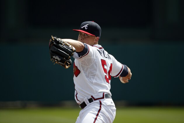 Atlanta Braves starting pitcher Kris Medlen (54) warms up from the mound before the first inning in a spring exhibition baseball game against the Washington Nationals, Tuesday, March 4, 2014, in Kissimmee, Fla. (AP Photo/Alex Brandon)