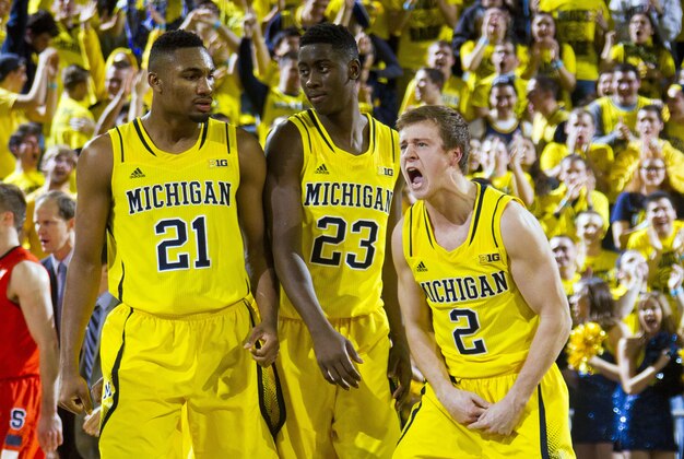 Michigan guard Spike Albrecht (2) celebrates with teammates Zak Irvin, and Caris LeVert during a timeout in the second half of an NCAA college basketball game at Crisler Center in Ann Arbor, Mich., Tuesday, Dec. 2, 2014. Michigan won 68-65. (AP Photo/Tony Ding)