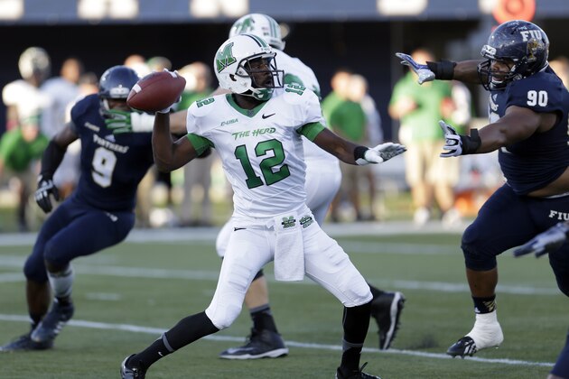 Marshall quarterback Rakeem Cato (12) prepares to pass against Florida International  during the first half of an NCAA  college football game, Saturday, Oct. 18, 2014, in Miami. (AP Photo/Alan Diaz)