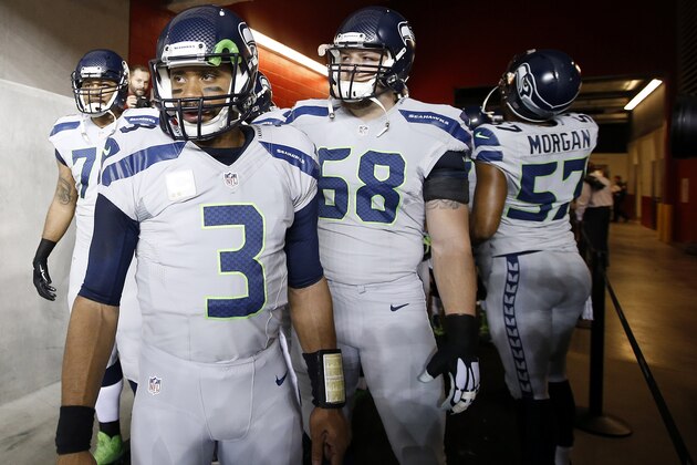 Seattle Seahawks quarterback Russell Wilson (3) stands with tackle Garry Gilliam, left,, offensive tackle Justin Britt (68) and linebacker Mike Morgan (57) in the Levi's Stadium tunnel before an NFL football game against the San Francisco 49ers in Santa Clara, Calif., Thursday, Nov. 27, 2014. (AP Photo/Tony Avelar)
