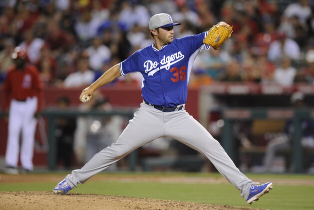 Los Angeles Dodgers pitcher Matt Magill pitches during the fifth inning of a spring exhibition baseball game against the Los Angeles Angels in Anaheim, Calif., Saturday, March 29, 2014. (AP Photo/Kelvin Kuo)