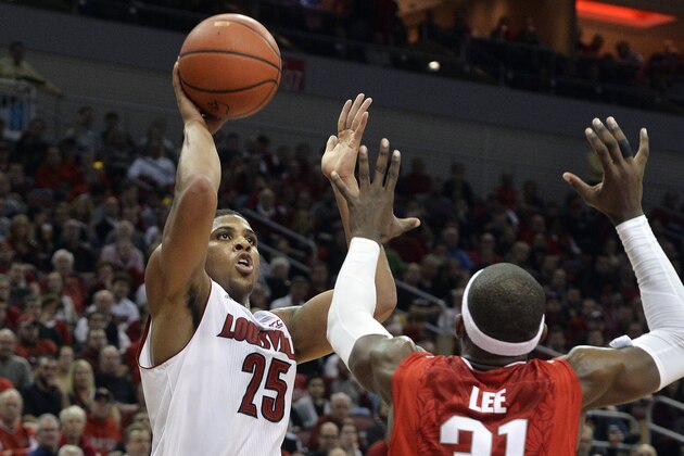 Louisville's Wayne Blackshear, left, puts up a shot over the defense of Ohio State's Anthony Lee during the second half of an NCAA college basketball game Tuesday, Dec. 2, 2014, in Louisville, Ky. Louisville won 64-55, and Blackshear led all scorers with 22 points. (AP Photo/Timothy D. Easley)