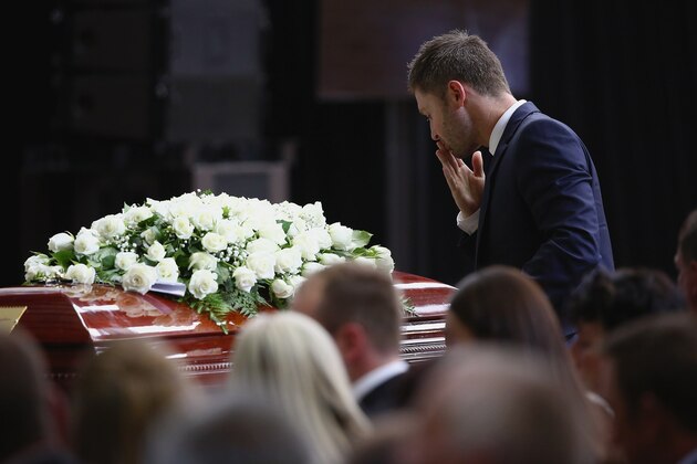 MACKSVILLE, AUSTRALIA - DECEMBER 03: Australian cricket captain Michael Clarke pays his respect to Phillip Hughes during the Funeral Service for Phillip Hughes on December 3, 2014 in Macksville, Australia. Australian cricketer Phillip Hughes passed away last Thursday, aged 25, as a result of head injuries sustained during the Sheffield Shield match between South Australia and New South Wales at the SCG on Tuesday 25th November. (Photo by Cameron Spencer - Pool/Getty Images)