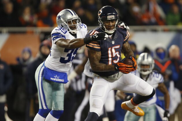 Chicago Bears wide receiver Brandon Marshall (15) makes a catch under pressure from Dallas Cowboys cornerback Brandon Carr (39) during the first half of an NFL football game, Monday, Dec. 9, 2013, in Chicago. (AP Photo/Charles Rex Arbogast)