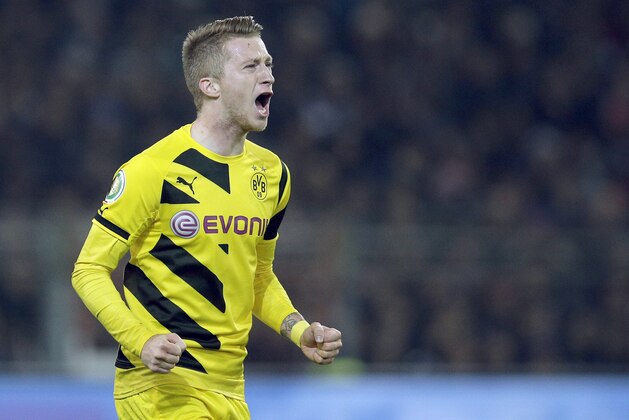 Dortmund's scorer Marco Reus shouts as he celebrates his side's second goal during the German soccer cup second round match between FC St. Pauli and Borussia Dortmund at the Millerntor Stadium in Hamburg, Germany, Tuesday, Oct. 28, 2014. (AP Photo/Michael Sohn)