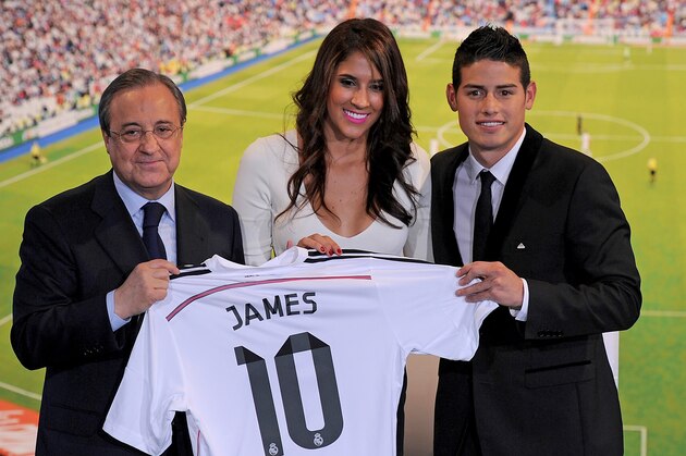 MADRID, SPAIN - JULY 22:  James Rodriguez holds his new Real shirt beside club president Florentino Perez and his wife Daniela Ospina during his unveiling as a new Real Madrid player at the Santaigo Bernabeu stadium on July 22, 2014 in Madrid, Spain. Real agreed to buy Rodriguez from AS Monaco for the next six seasons for an undisclosed transfer fee.  (Photo by Denis Doyle/Getty Images)