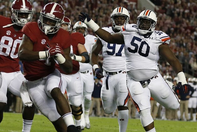 Alabama running back T.J. Yeldon (4) runs into the end zone for a touchdown against Auburn during the first half of the Iron Bowl NCAA college football game, Saturday, Nov. 29, 2014, in Tuscaloosa, Ala. (AP Photo/Brynn Anderson )