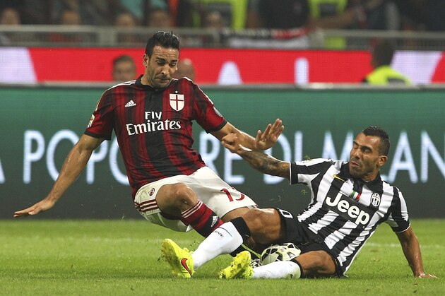MILAN, ITALY - SEPTEMBER 20:  Adil Rami of AC Milan clashes with Carlos Tevez of Juventus FC during the Serie A match between AC Milan and Juventus FC at Stadio Giuseppe Meazza on September 20, 2014 in Milan, Italy.  (Photo by Marco Luzzani/Getty Images)
