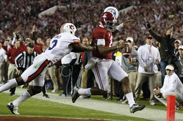 Alabama quarterback Blake Sims (6) runs into the end zone for a touchdown against Auburn defensive back Jonathan Jones (3) during the second half of the Iron Bowl NCAA college football game, Saturday, Nov. 29, 2014, in Tuscaloosa, Ala. (AP Photo/Brynn Anderson )
