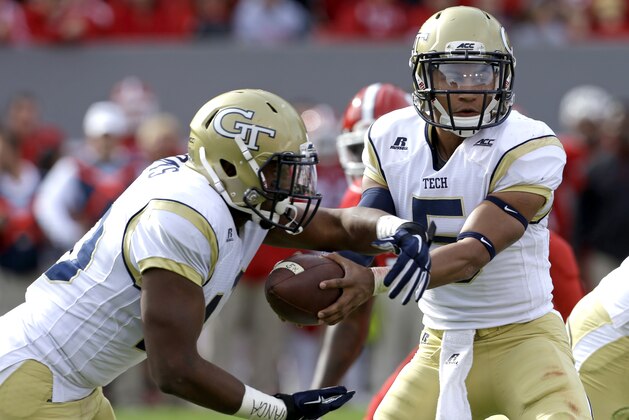 North Carolina State quarterback Justin Thomas (5) hands off to Synjyn Days during the first half of an NCAA college football game in Raleigh, N.C., Saturday, Nov. 8, 2014. (AP Photo/Gerry Broome)