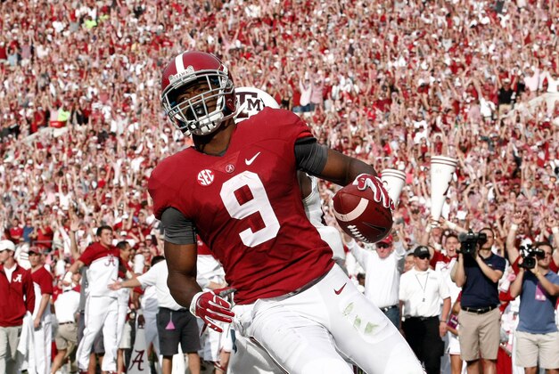 Oct 18, 2014; Tuscaloosa, AL, USA; Alabama Crimson Tide wide receiver Amari Cooper (9) catches a pass for a touchdown against the Texas A&M Aggies at Bryant-Denny Stadium. Mandatory Credit: Marvin Gentry-USA TODAY Sports