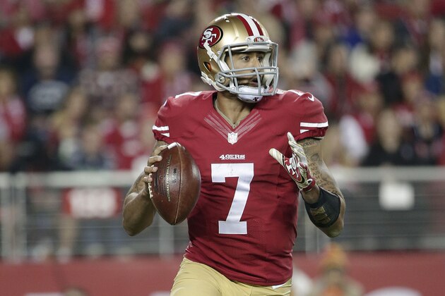 San Francisco 49ers quarterback Colin Kaepernick (7) rolls out against the Seattle Seahawks during the third quarter of an NFL football game in Santa Clara, Calif., Thursday, Nov. 27, 2014. (AP Photo/Marcio Jose Sanchez)