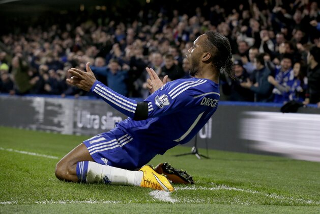 Chelsea's Didier Drogba celebrates scoring his side's second goal during the English Premier League soccer match between Chelsea and Tottenham Hotspur at Stamford Bridge stadium in London, Wednesday, Dec. 3, 2014.  (AP Photo/Matt Dunham)