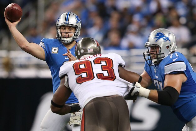 DETROIT, MI - NOVEMBER 24: Matthew Stafford #9 of the Detroit Lions drops back to make a pass as teammate Riely Reiff #71 and Gerald McCoy #93 of the Tampa Bay Buccaneers battle during the third quarter of the game at Ford Field on November 24, 2013 in Detroit, Michigan. Tampa Bay defeted the Lions 24-21. (Photo by Leon Halip/Getty Images)