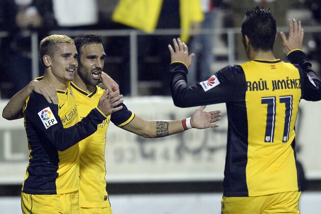 Atletico Madrid's Antoine Griezmann, from France, left, celebrates with his teammates after scoring during a Copa del Rey soccer match against Hospitalet at the Municipal stadium in Hospitalet Llobregat, Spain, Wednesday, Dec. 3, 2014. (AP Photo/Manu Fernandez)