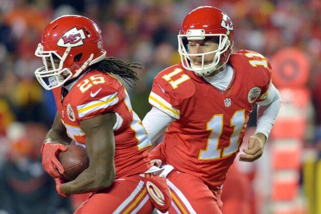 Nov 30, 2014; Kansas City, MO, USA; Kansas City Chiefs quarterback Alex Smith (11) hands off to running back Jamaal Charles (25) during the first half against the Denver Broncos at Arrowhead Stadium. Mandatory Credit: Denny Medley-USA TODAY Sports