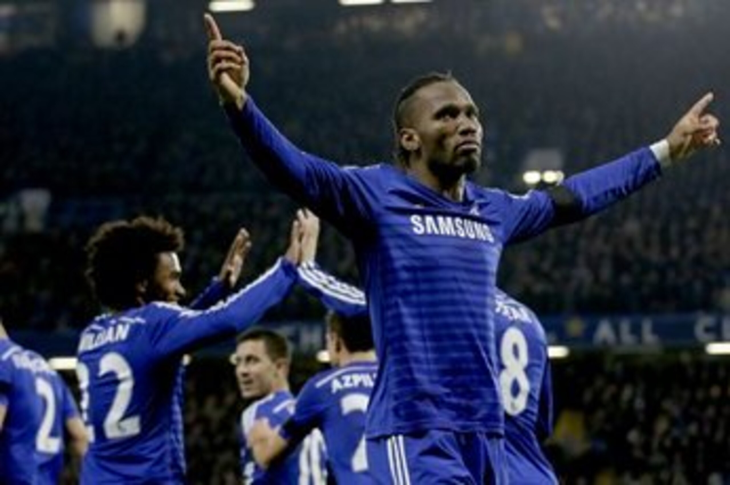 Chelsea's Didier Drogba, right, celebrates scoring his side's second goal during the English Premier League soccer match between Chelsea and Tottenham Hotspur at Stamford Bridge stadium in London, Wednesday, Dec. 3, 2014.  (AP Photo/Matt Dunham)